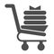 Shopping trolley with new clothes glyph icon. Market basket with fabric products. Commerce vector design concept, solid