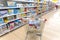 A shopping trolley stands in the department of children`s toys in a supermarket