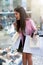 Shopping woman excited into a window of a shoe shop