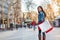 Shopping woman happy social distancing walking outside with bags. Asian multiethnic shopper girl model on La Rambla