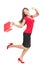 Shopping woman in joy running holding bag