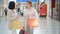 Shopping women talking happy holding shopping bags having fun laughing. Two beautiful young woman girlfriends in a