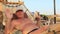 On the shore of the Kars Sea in Egypt, a young man in a sun cap rests in a hammock on a sunny summer day in the shade of palm tree