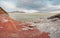 The shore of the Krasnoyarsk reservoir without water, red stones