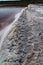 The shore of the Kuyalnitsky estuary, which became shallow during a drought, covered with crystals of self-sedimentary table salt