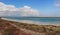 The shore of Lake Karakol in Kazakhstan, Aktau. Beautiful clouds hang very low over the lake. Panorama of steppe.