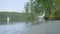 Shore of lake with white boat background. Row Boat floating, anchored off shore, on a lake with perfect reflection of