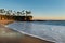 Shore with palm trees, rocks, blue sky and ocean