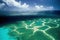 Shore underwater reefs in blue ocean under sky and clouds seascape.