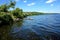 The shore of a wide river with people built for fishing ladders