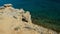 Shoreline arid rock above Sveta Maria beach on Pag Island, Croatia, clear azure blue water.