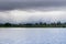 Shoreline lake on a cloudy day, rain pouring in the background, Mountain View, San Francisco bay area, California