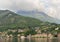 Shoreline of Menaggio on Lake Como with cloud shrouded hilltops in the background.