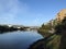 Shoreline of Mission Creek lined with buildings and highway going over creek