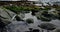 Shoreline of rocks with water puddles