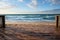 Shoreline stage Blurred beach forms backdrop for wooden decks versatile product displays