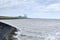 Shoreline towards harlingen in the Netherlands with grassland dike, Fish industry, wind turbines, port, harbor and