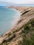 Shoreline view of sand dunes by lake in Michigan