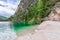 The shores of the famous Alpine Lake Braies with crystal emerald water