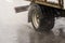 short box truck moving on a wet road with splashes during the day