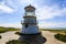 Short coastal lighthouse along shore of California