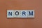 Short gray word norm made of wooden square letters