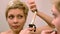 Short hair woman curls her hair with curling iron