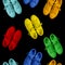 Short low brigt multicolored and white sneakers on a Black background. Seamless pattern.