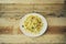short mafalde pasta dish with sausage and zucchini, rough wood b
