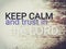 Short message saying Keep calm and trust in the Lord.  Text on wood background saying keep calm and trust in the Lord.