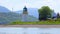 Short white lighthouse on seashore