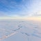 Short winter day above frozen tundra, top view