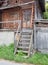 Short wooden stairs to old wooden cabin
