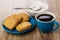 Shortbread cookies in saucer, sugar, spoon in bowl, coffee in cu