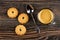 Shortbread cookies, spoon, cup with coffee espresso on wooden table. Top view