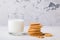 Shortbread kamut cookies with glass of milk on light background