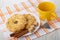 Shortbread rings with peanut, sugar, cinnamon stick in plate, teaspoon in cup, tea bag on napkin on table