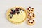 Shortbread vanilla tartlets with fruits, chocolate heart and edible daisy flowers