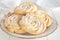 Shortbread whipped nuts cookies on white plate. White wooden background. Copy space. Close up