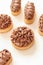 Shortcrust tartlets with chocolate cream on a light background