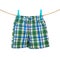 Shorts hanging on the clothesline on white background