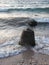 shot of an anchor concrete block on the beach by the sea