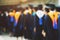 Shot backside group crowd of graduation hats during commencement success graduates