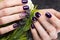 Shot beautiful manicure with flowers on female fingers. Nails design. Close-up