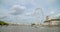 A shot of a boat passing the London Eye