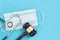 Shot brown gavel, medical stethoscope and mask on a blue background. the concept of medical error.. free copy space for