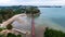 Shot of Burung island featuring a vibrant red pier stretching out over the vast expanse of the ocean