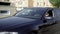 Shot of a businessman driving a clean, shiny black car.