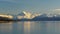 A shot of a calm lake pukaki with a snowy mt cook