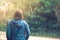 Shot of a Caucasian girl captured from the back with short blonde hair and a blue hoodie.